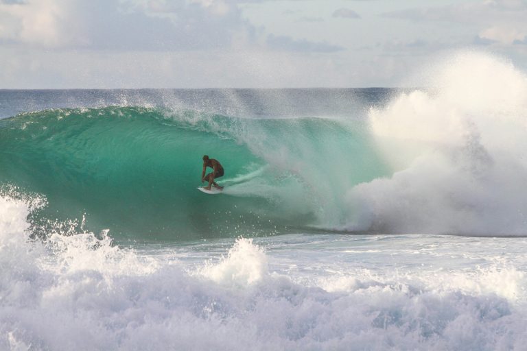Surfer riding waves on electric surfboard jetboard