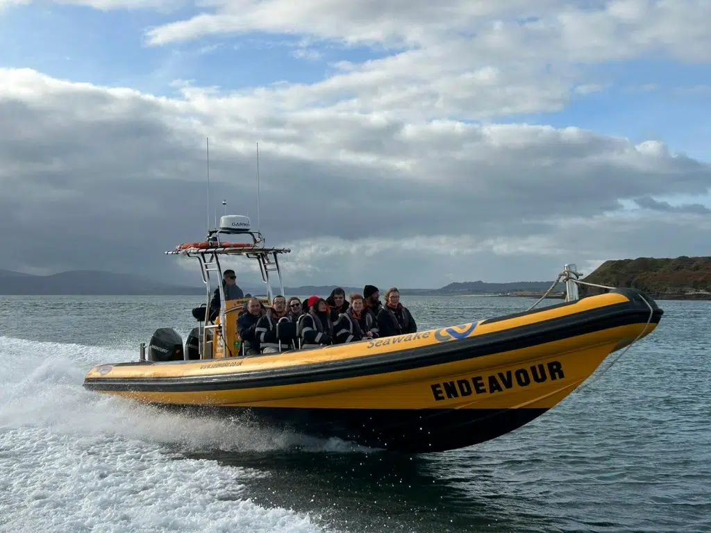 RIB boat on the Menai Strait with bridges in the background