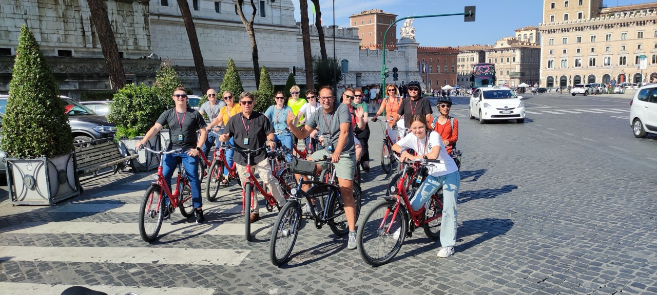 A guided bike group stopped in a Rome square