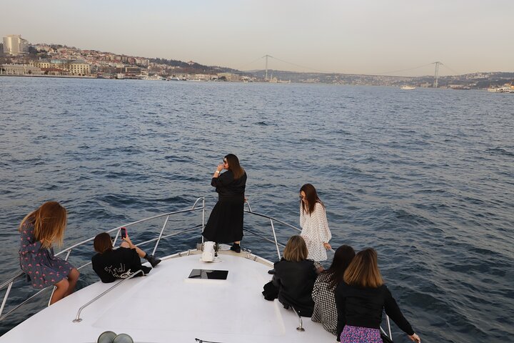 Guests on the bow of a yacht on the Bosphorus at sunset