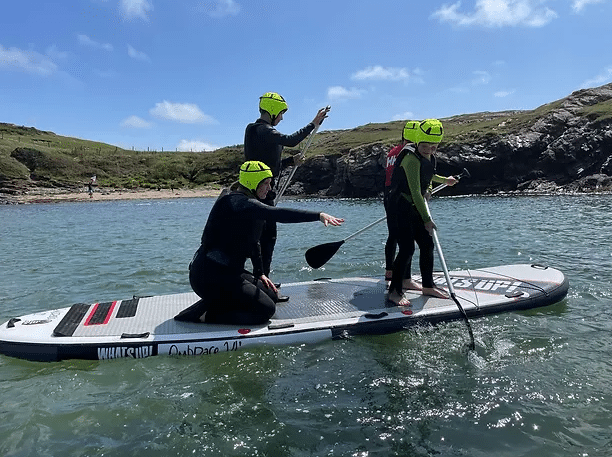 Group on a giant SUP off the Anglesey coast