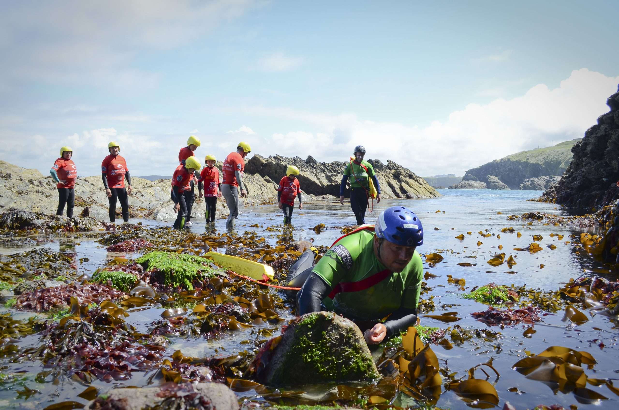 Coasteering scramble on the rocks, Newquay, Cornwall